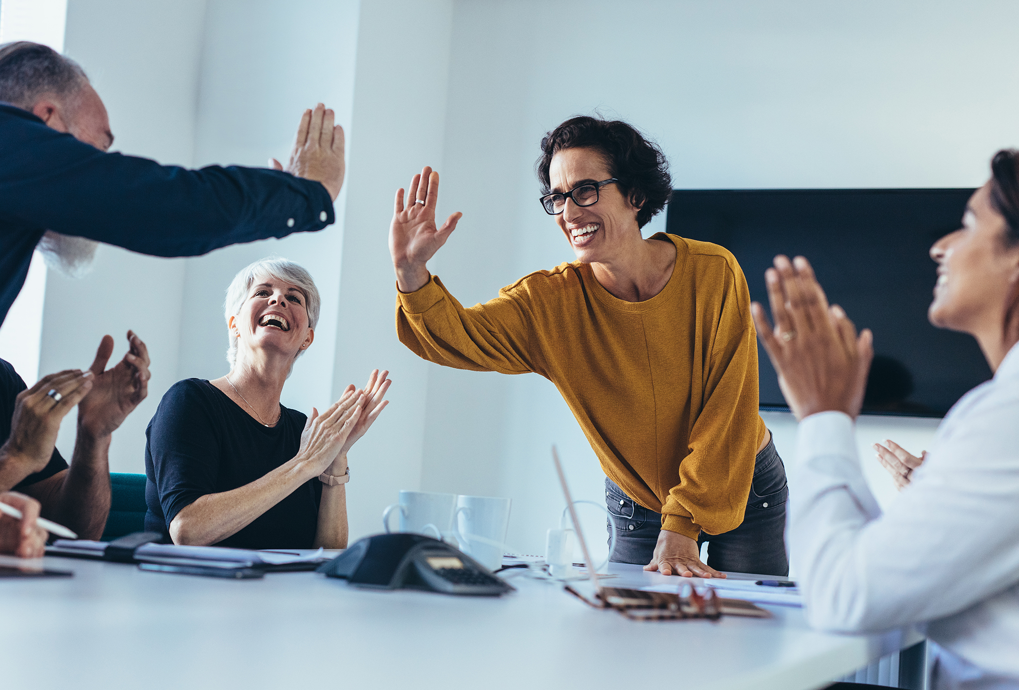 Business people giving each other high five and clapping. Business team celebrating success.